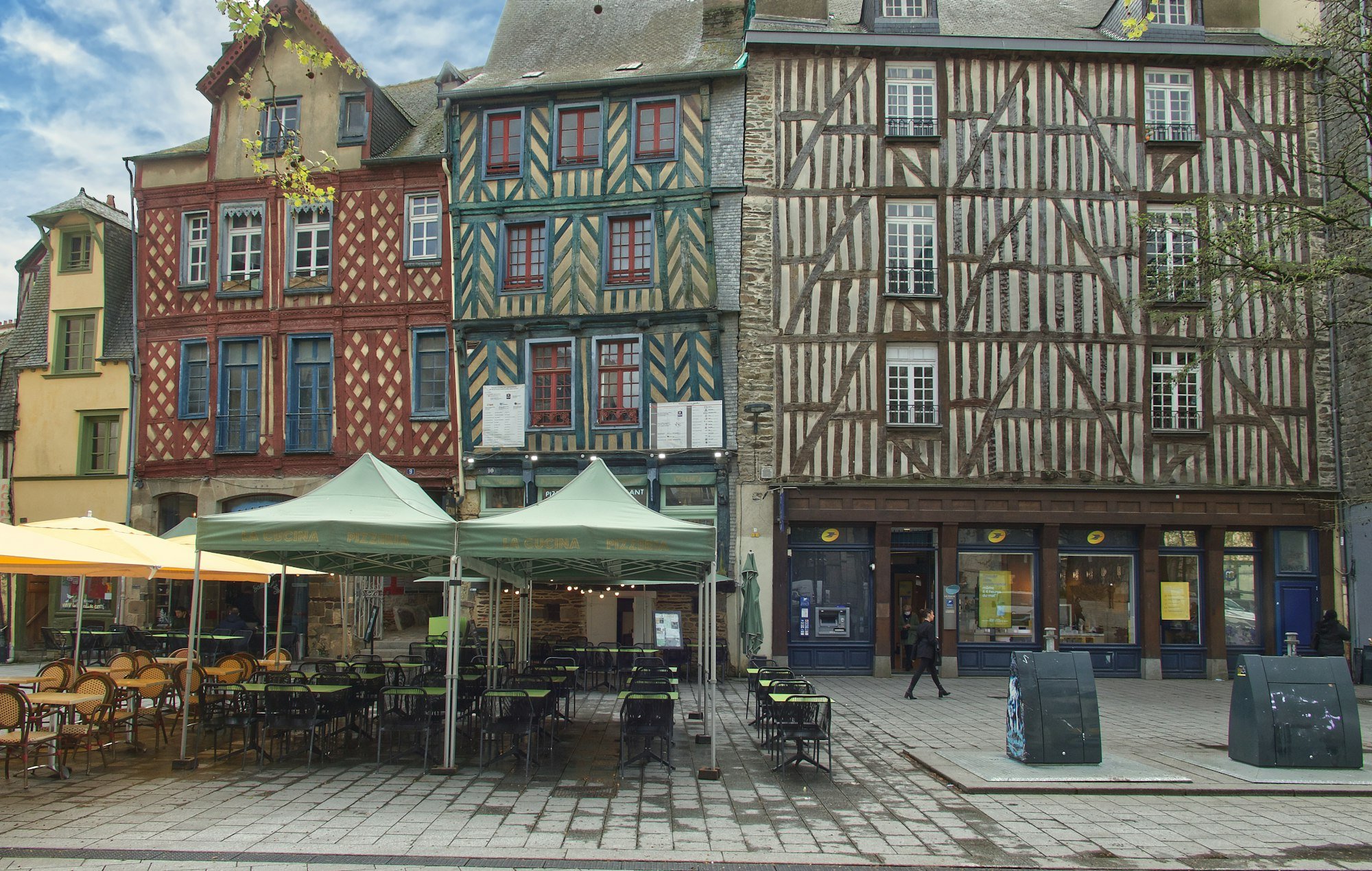 The colourful half-timbered houses of a square in central Rennes